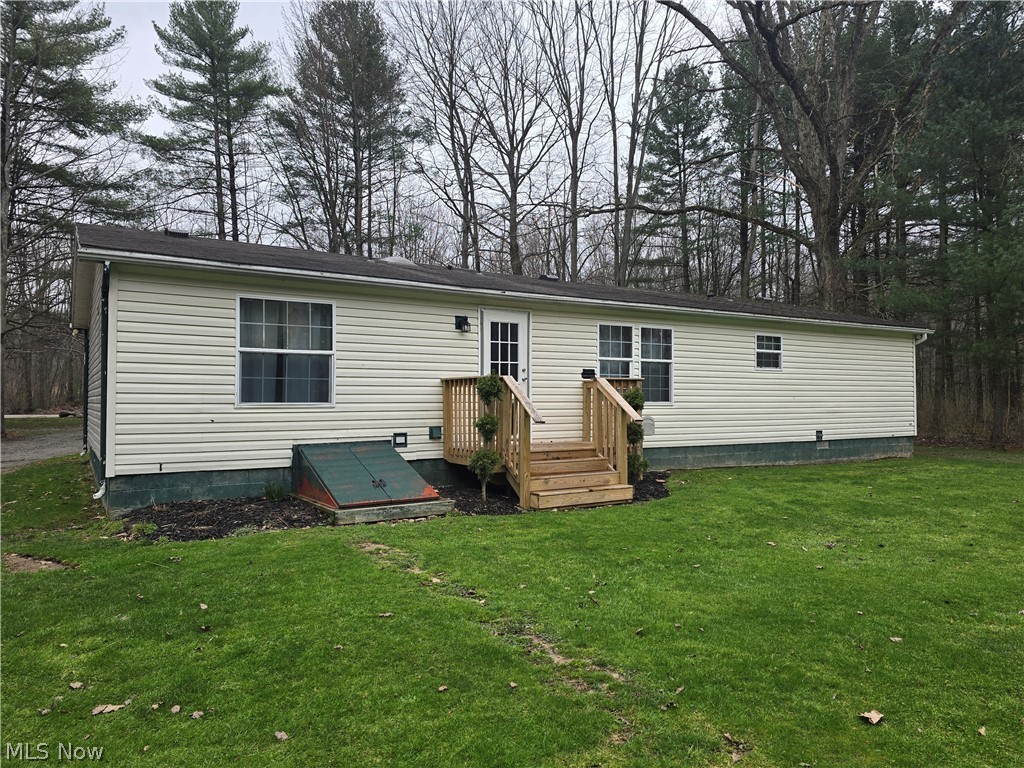 1389 Old Kyle Road Dorset, OH 44032 - Photo 3 of 14 Back of house featuring a lawn and a deck