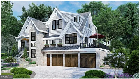 a view of a white house with large windows and a small yard