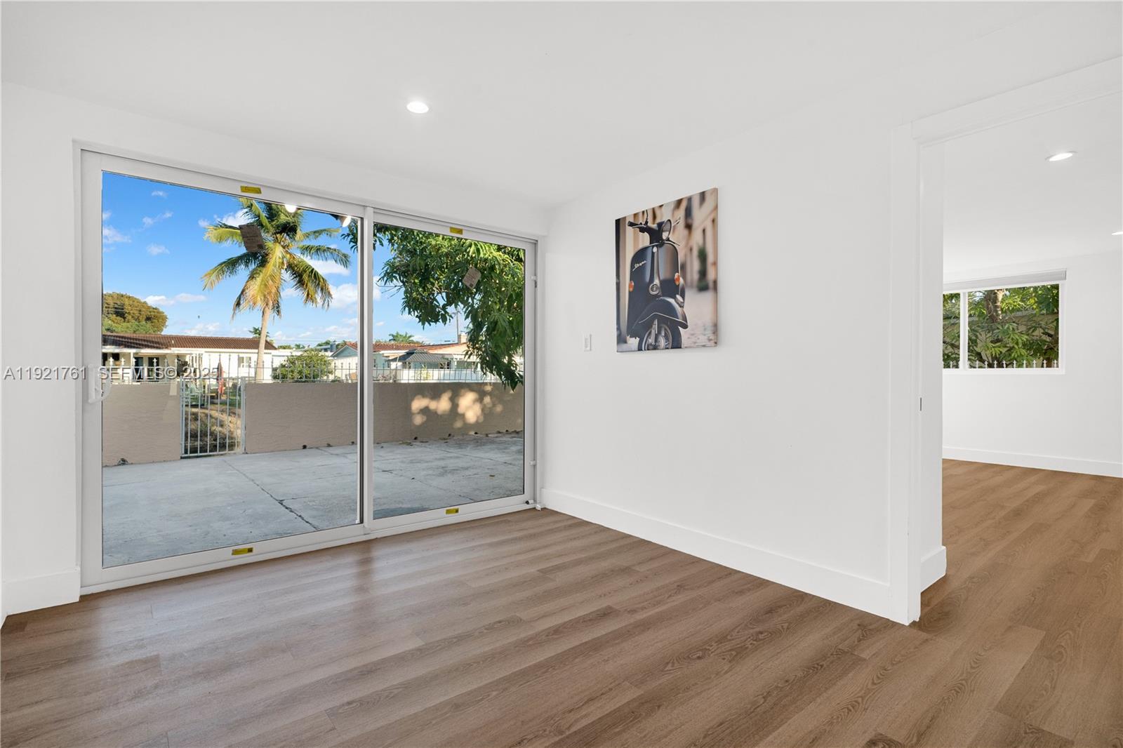 4701 Southwest 104th Court Miami, FL 33165 - Photo 6 of 16 an empty room with wooden floor and door