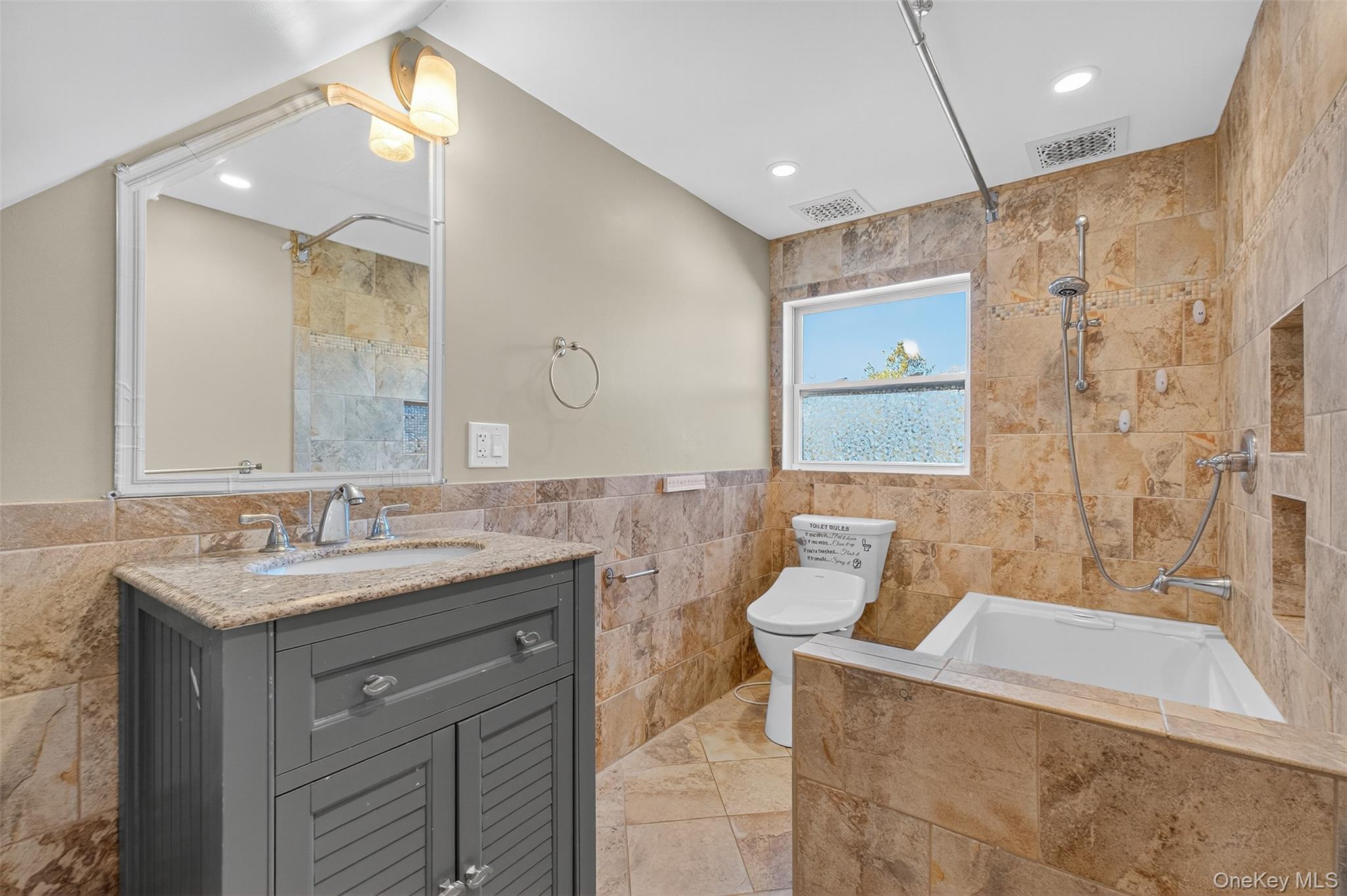 23 Creek Road Staatsburg, NY 12580 - Photo 13 of 39 a bathroom with a granite countertop sink a mirror a bathtub and shower
