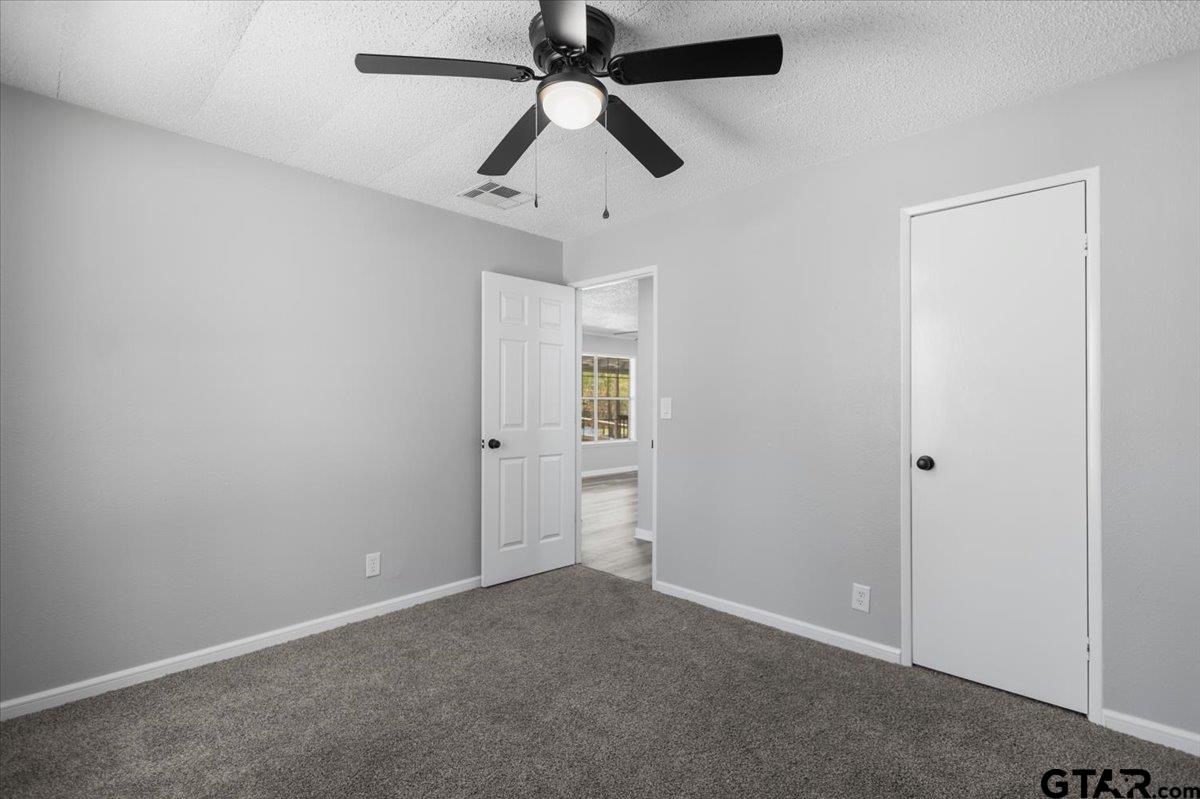 18607-c R 498 C R 498 Lindale, TX 75771 - Photo 24 of 41 an empty room with closet and a ceiling fan