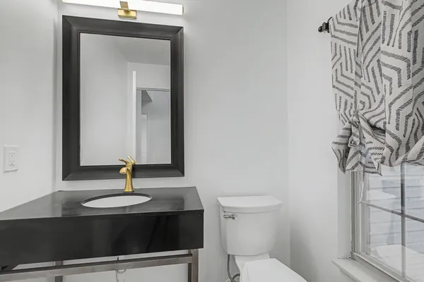 a view of a livingroom with furniture and a window