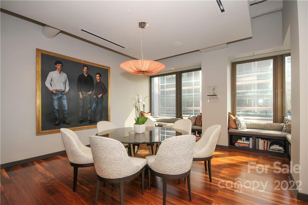 139 South Tryon Street Charlotte, NC 28202 - Photo 12 of 48 a view of a dining room with furniture wooden floor and a chandelier