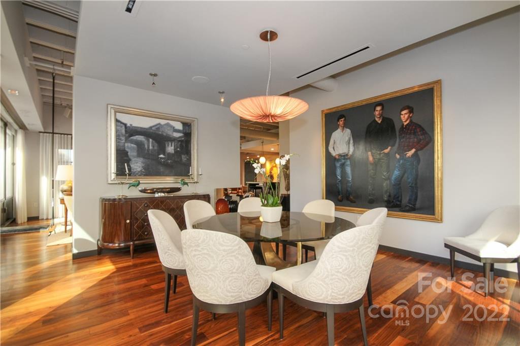 139 South Tryon Street Charlotte, NC 28202 - Photo 14 of 48 a view of a dining room with furniture wooden floor and a chandelier