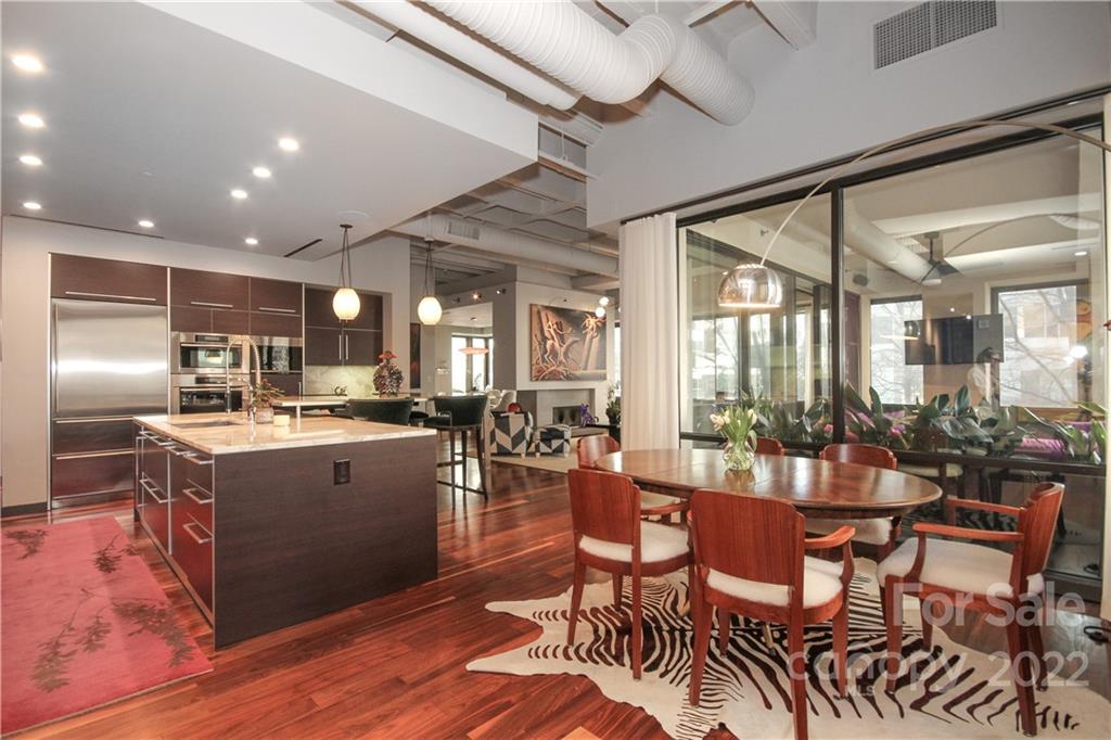 139 South Tryon Street Charlotte, NC 28202 - Photo 16 of 48 a kitchen with a table chairs refrigerator and cabinets