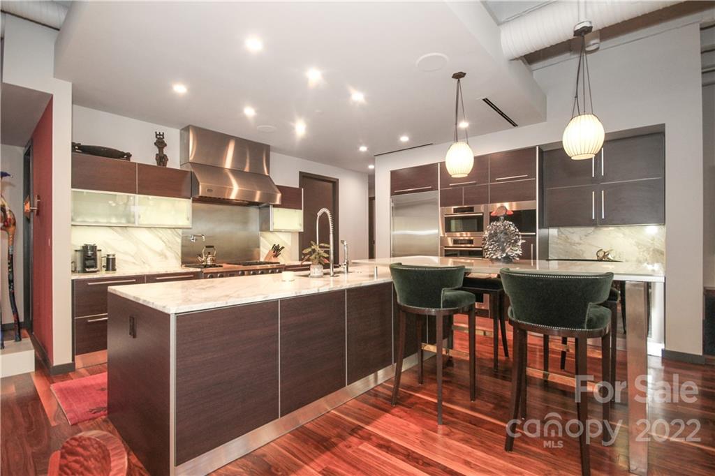 139 South Tryon Street Charlotte, NC 28202 - Photo 18 of 48 a kitchen with a sink cabinets and wooden floor