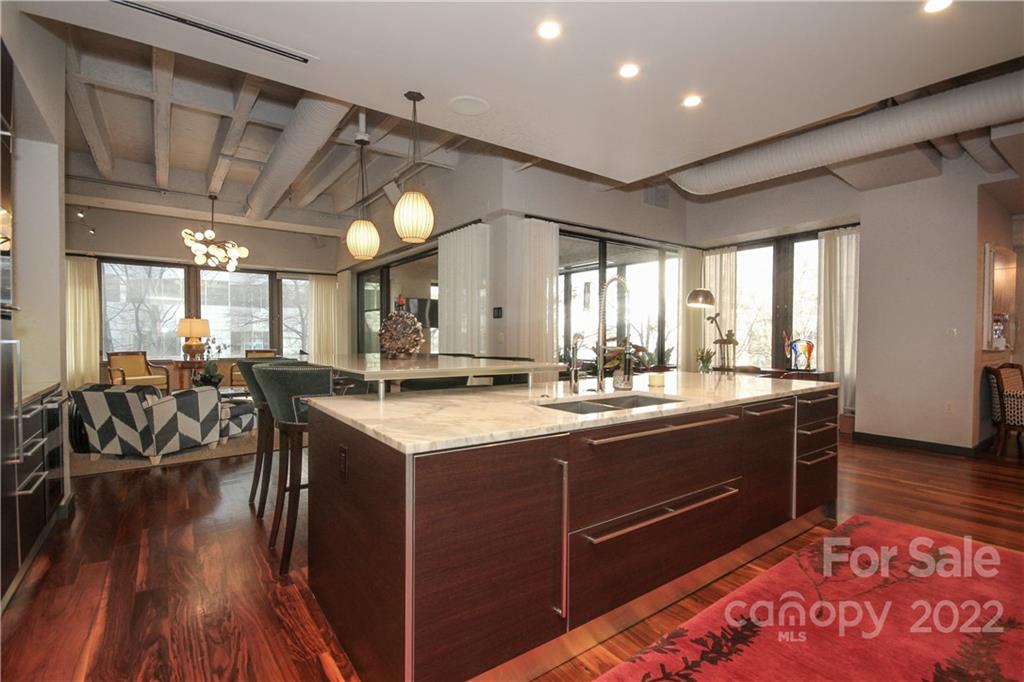 139 South Tryon Street Charlotte, NC 28202 - Photo 21 of 48 a kitchen with stainless steel appliances granite countertop a sink a stove and a wooden floors