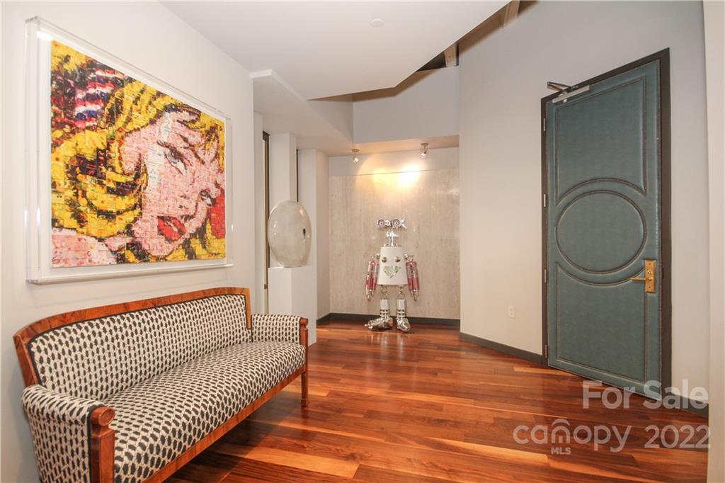 139 South Tryon Street Charlotte, NC 28202 - Photo 3 of 48 a view of a hallway with wooden floor and furniture