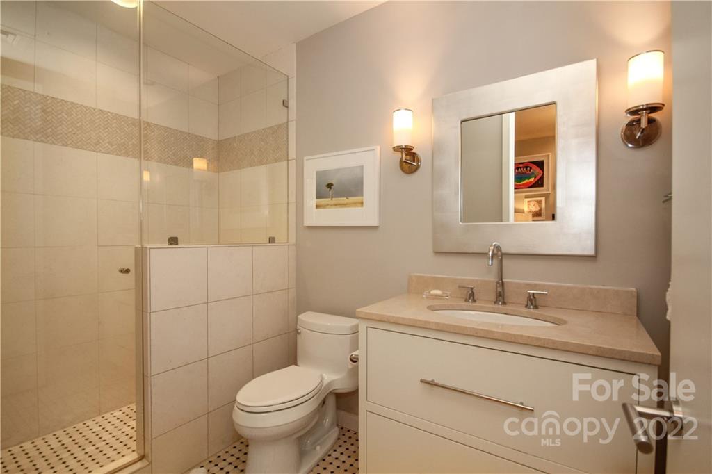 139 South Tryon Street Charlotte, NC 28202 - Photo 38 of 48 a bathroom with a toilet sink and mirror