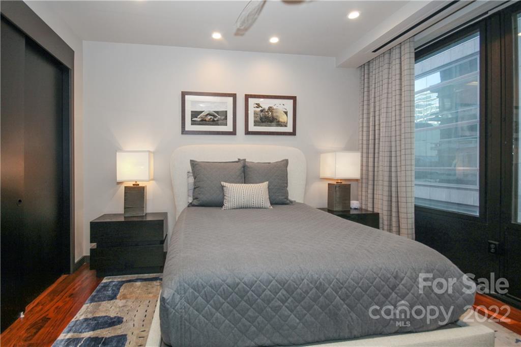 139 South Tryon Street Charlotte, NC 28202 - Photo 39 of 48 a bedroom with a bed and wooden floor