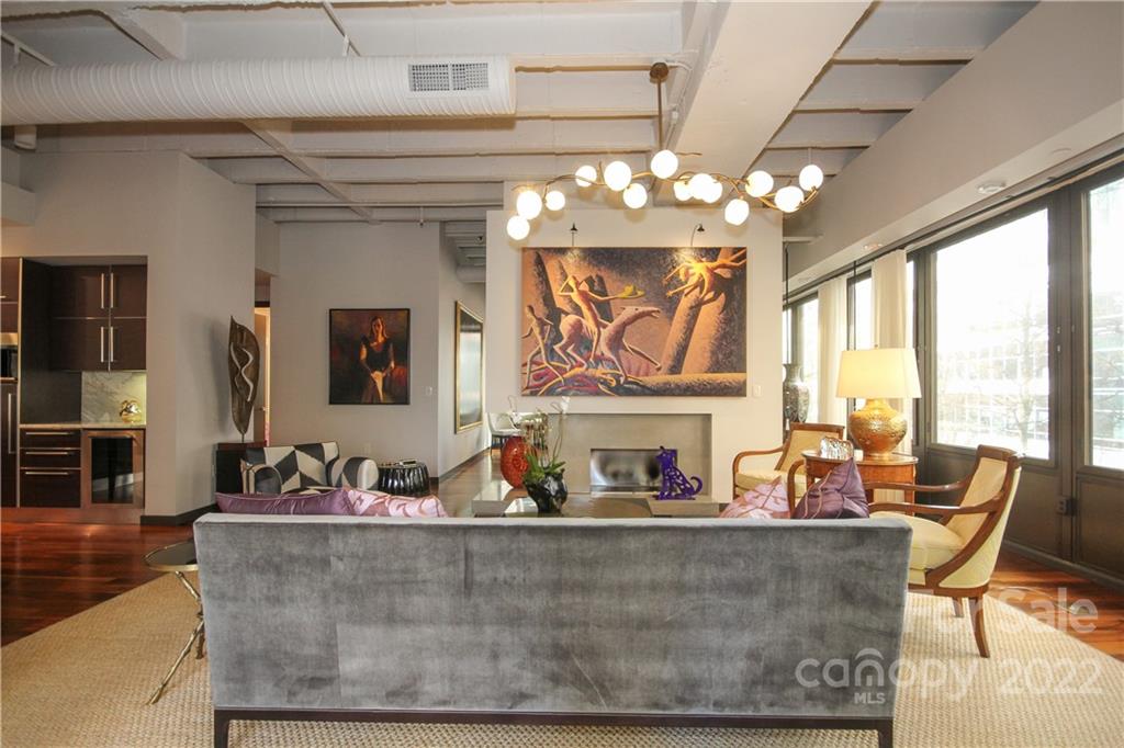 139 South Tryon Street Charlotte, NC 28202 - Photo 8 of 48 a view of a dining room with furniture a chandelier and large windows