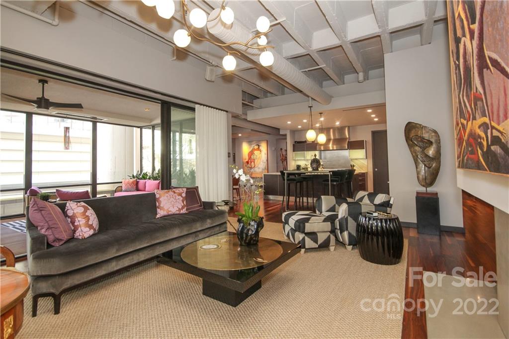 139 South Tryon Street Charlotte, NC 28202 - Photo 10 of 48 a living room with furniture a chandelier and a large window