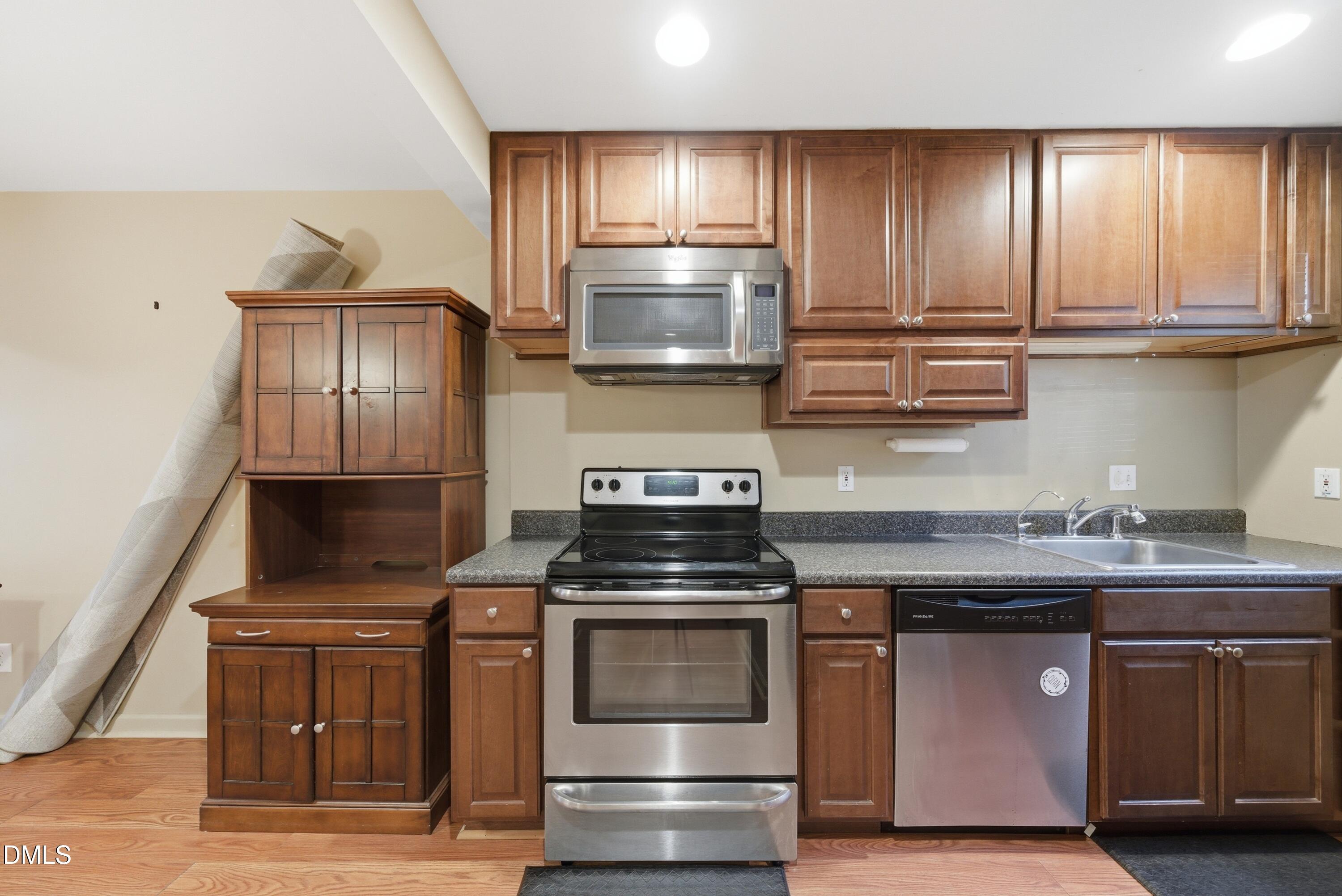 6355 New Market Way Raleigh, NC 27615 - Photo 9 of 30 a kitchen with stainless steel appliances granite countertop a stove and a microwave