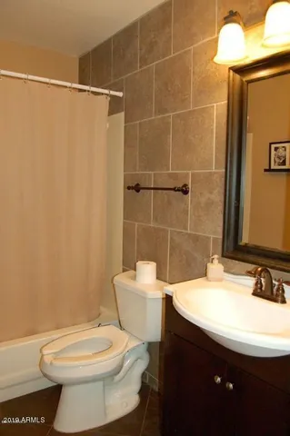 a bathroom with double sink and two mirror