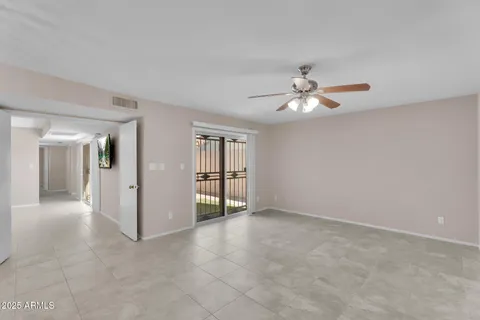 a view of an empty room with a ceiling fan