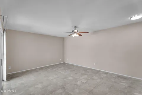 a view of an empty room with a fan