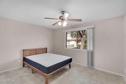 a bedroom with a bed and window