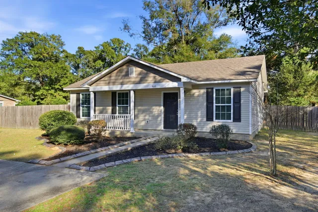 a front view of a house with a garden