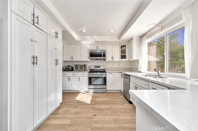 a kitchen with stainless steel appliances granite countertop a stove and a refrigerator