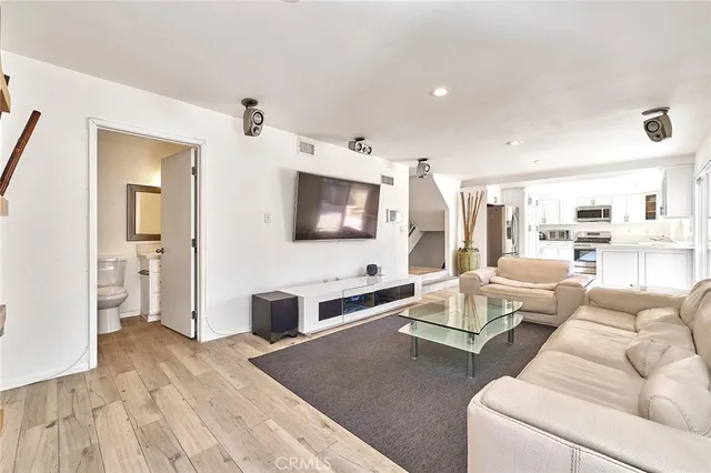 a living room with furniture wooden floor and a flat screen tv