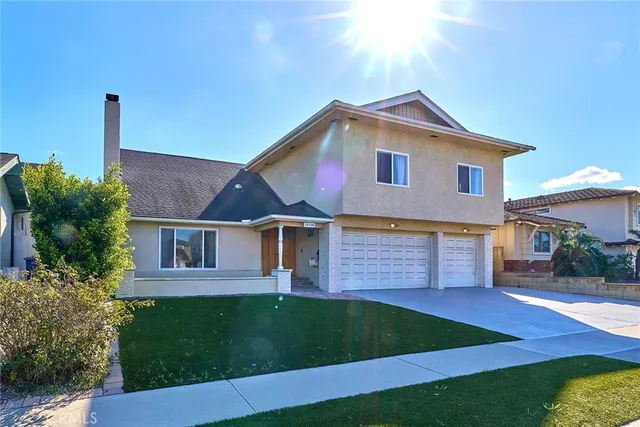 a front view of a house with a garden and yard