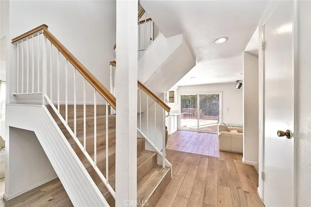 a view of entryway with wooden floor and stairs