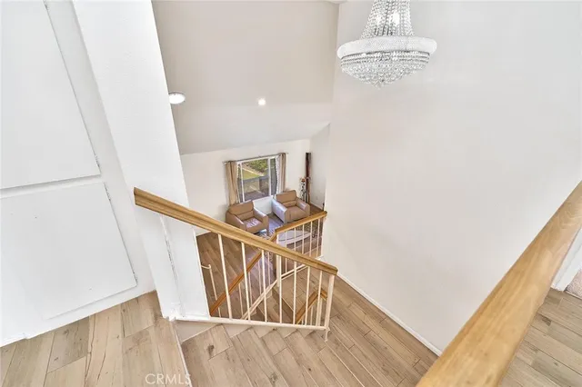a view of a hallway with wooden floor and dining room