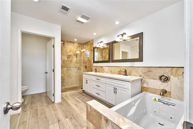 a bathroom with a sink and a glass door shower