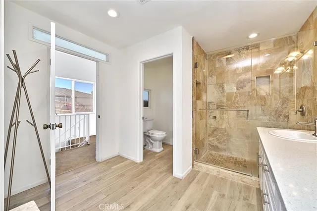 a bathroom with a sink a toilet and a large mirror