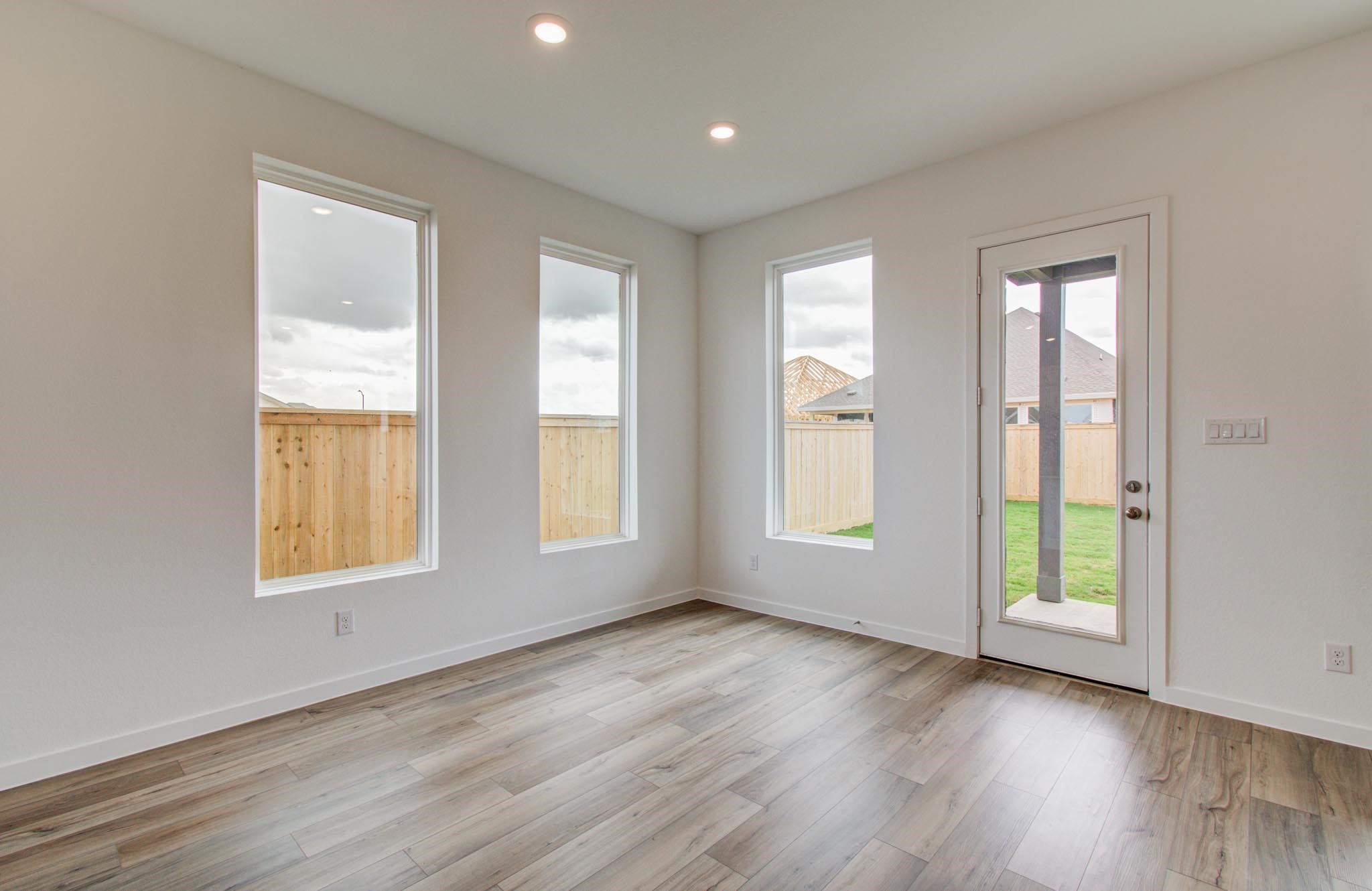 11122 Swamp Edge Lane Cypress, TX 77433 - Photo 13 of 43 an empty room with wooden floor and windows