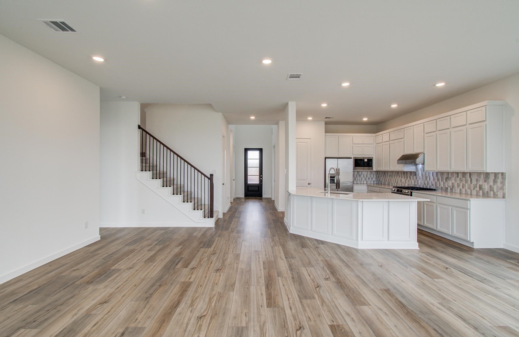11122 Swamp Edge Lane Cypress, TX 77433 - Photo 15 of 43 a view of kitchen with microwave a refrigerator and a stove top oven