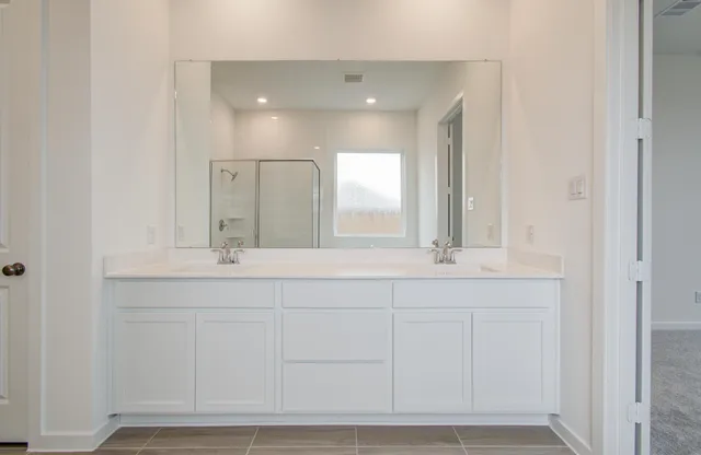 a bathroom with a sink and vanity