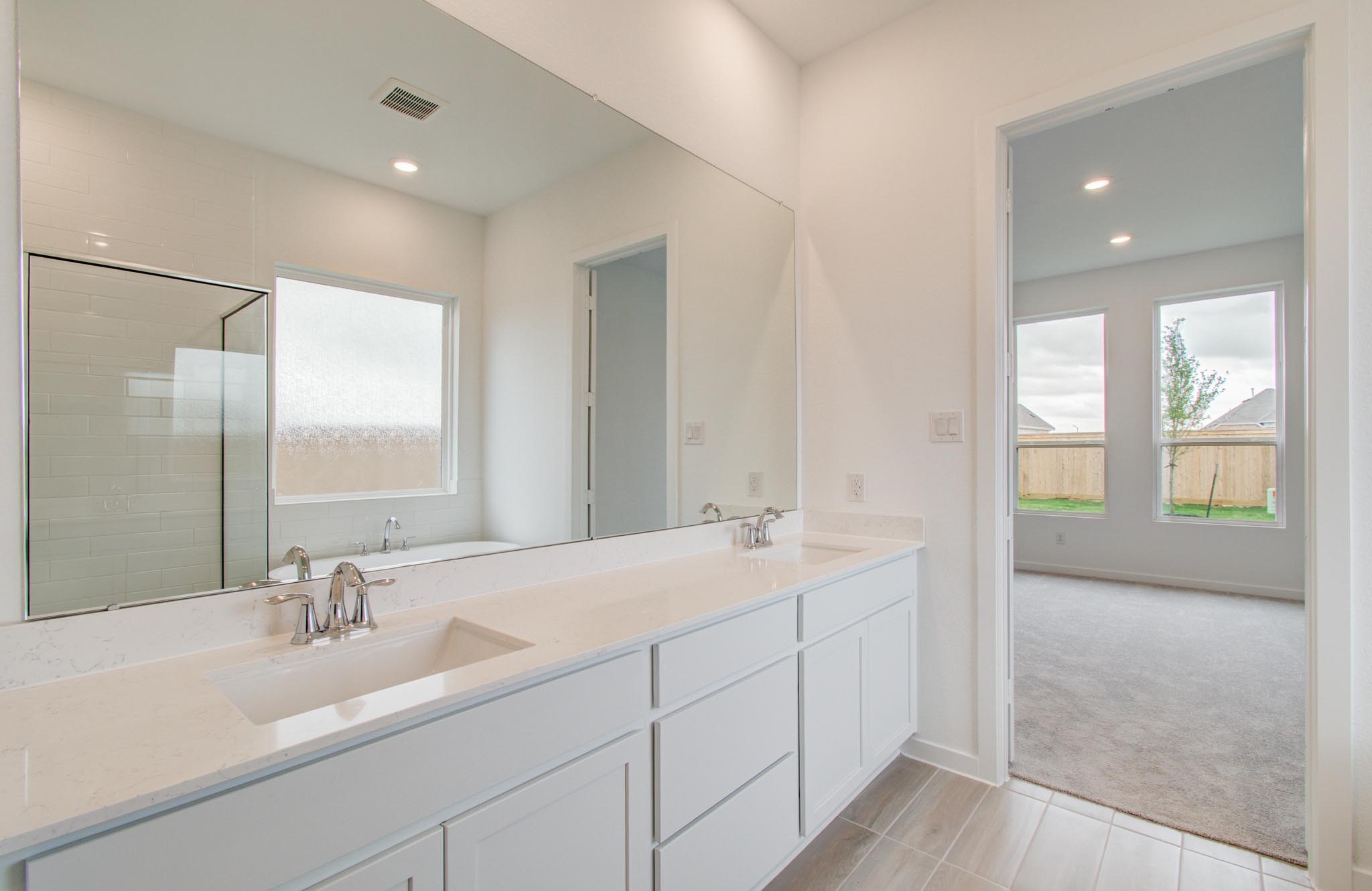 11122 Swamp Edge Lane Cypress, TX 77433 - Photo 24 of 43 a bathroom with a sink double vanity and a mirror
