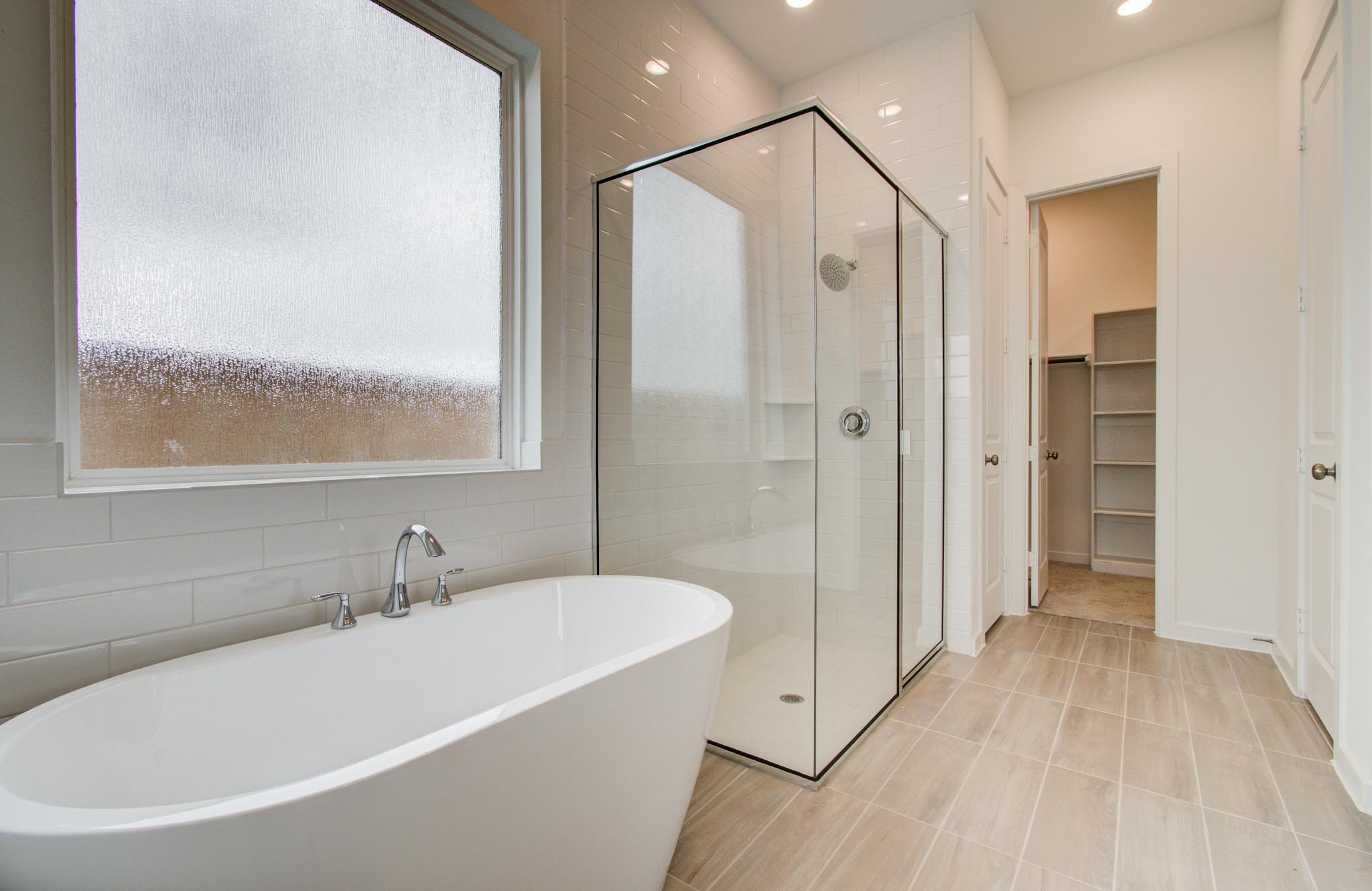 11122 Swamp Edge Lane Cypress, TX 77433 - Photo 25 of 43 a bathroom with a bathtub and a shower