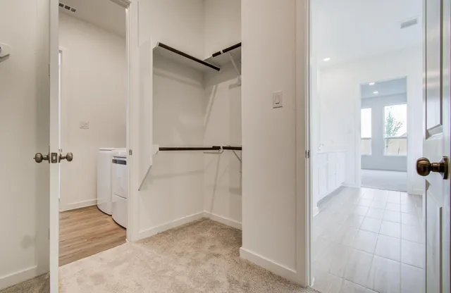 an empty room with windows and closet