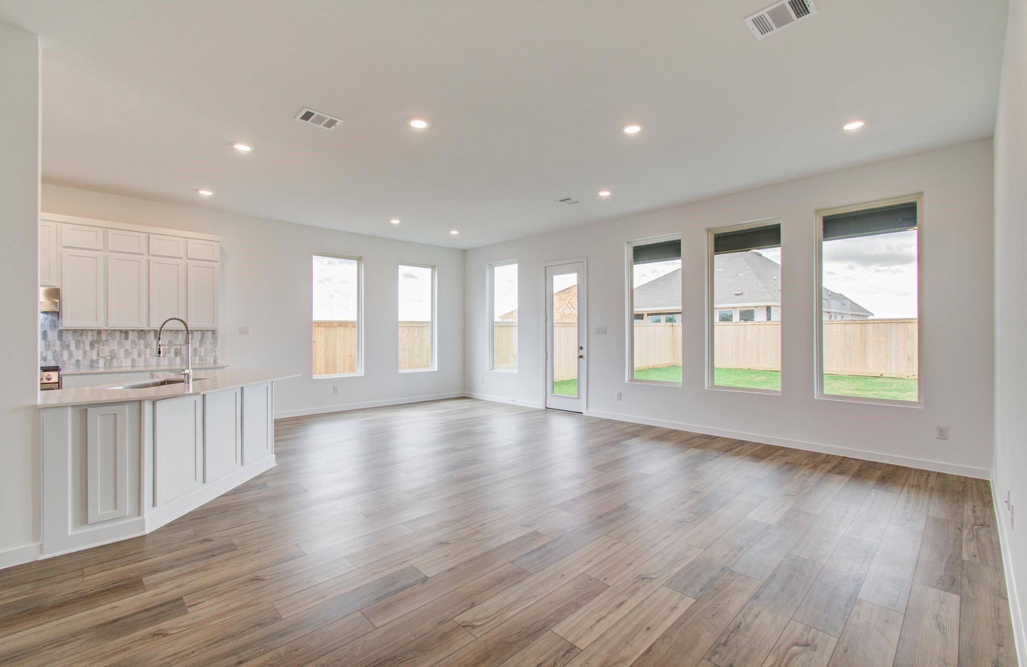 11122 Swamp Edge Lane Cypress, TX 77433 - Photo 10 of 43 a view of an empty room with wooden floor and a window