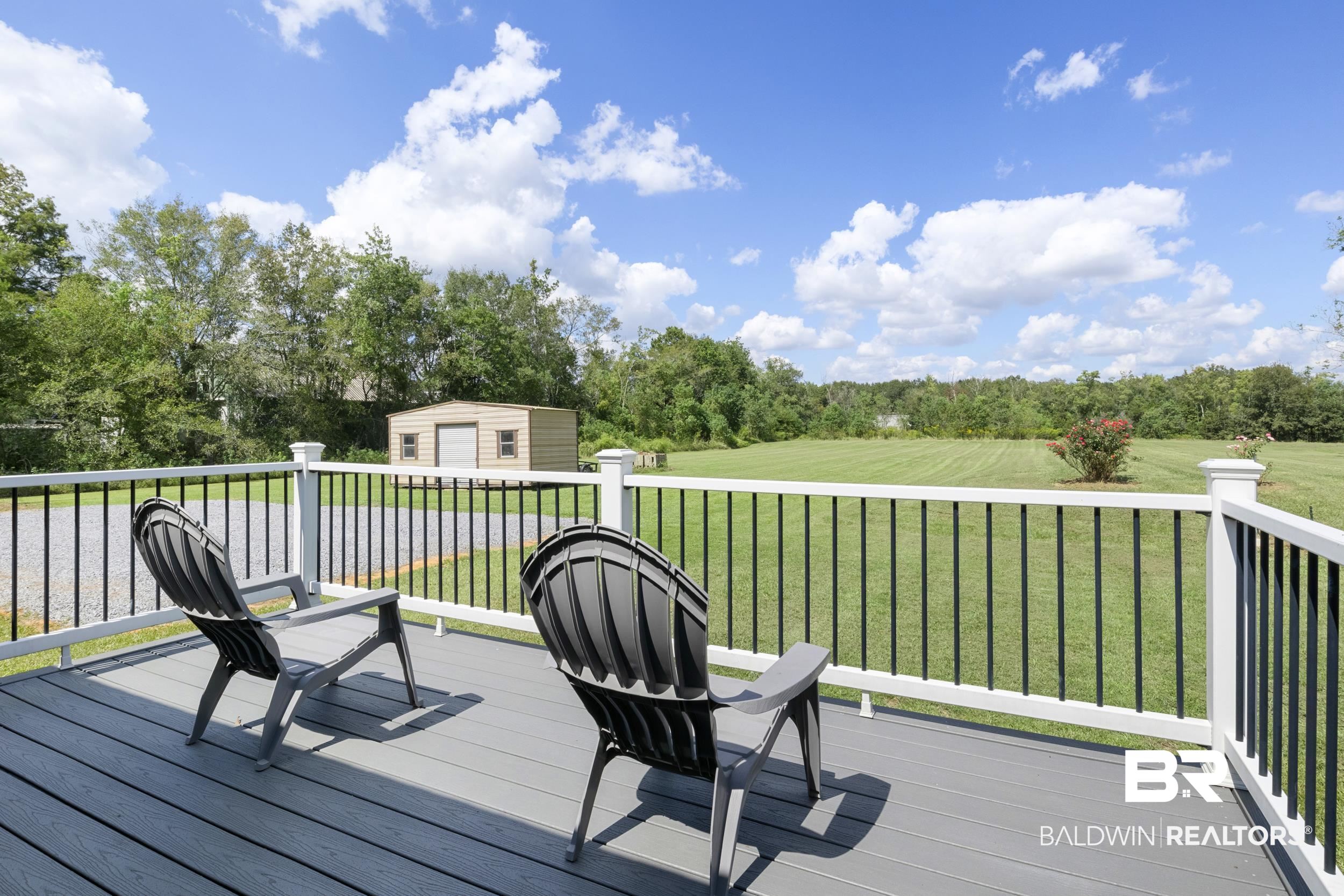 17689 Brewer Road Foley, AL 36535 - Photo 8 of 54 Deck featuring a yard and a storage unit