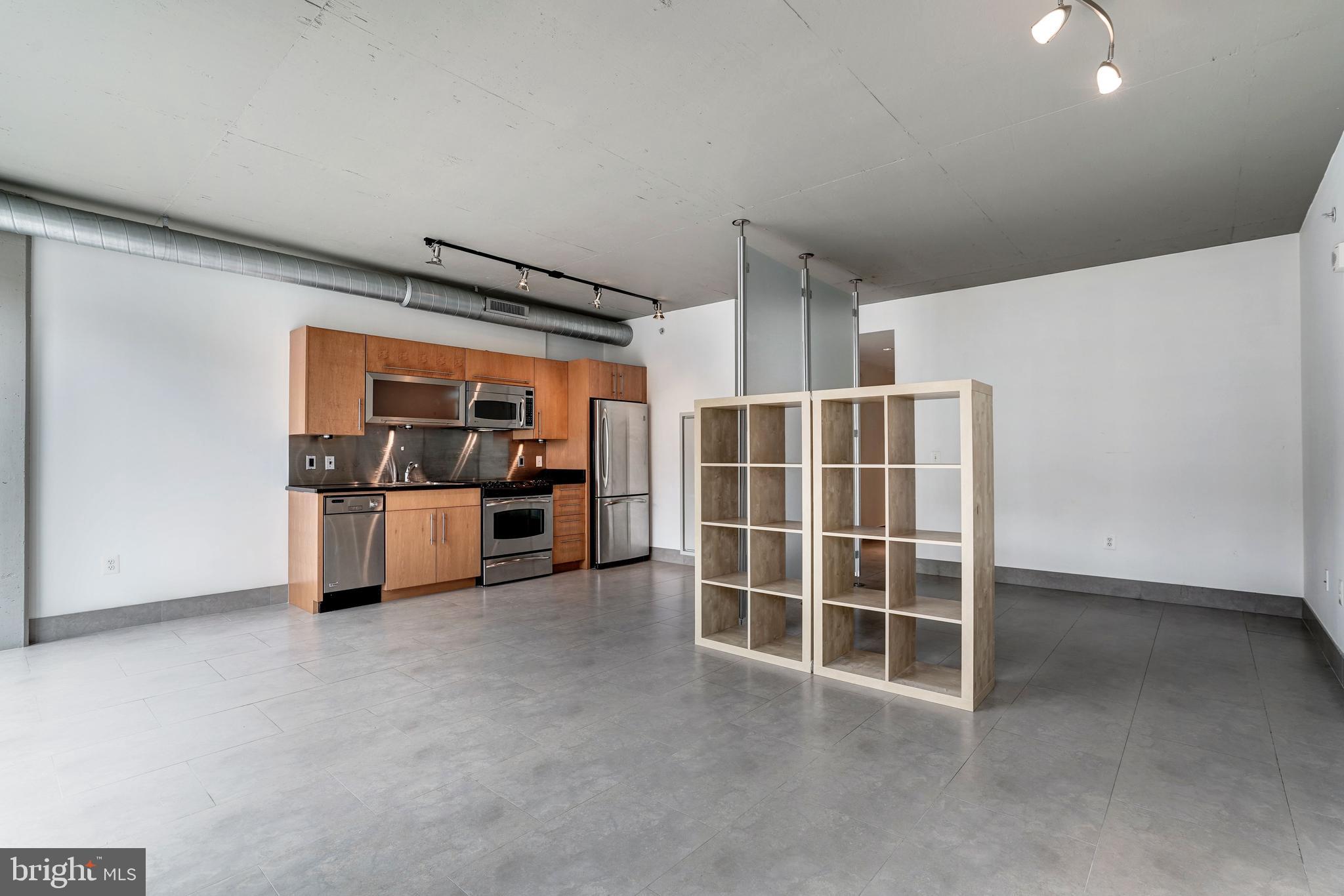 1133 14th Street Northwest, Unit 809 Washington, DC 20005 - Photo 7 of 27 a view of kitchen with refrigerator and more cabinets