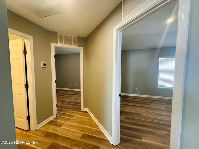 a view of a livingroom with wooden floor and a staircase