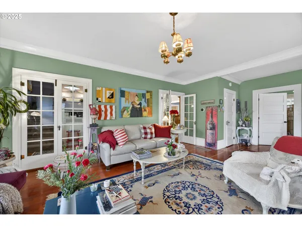 a living room with furniture and a chandelier