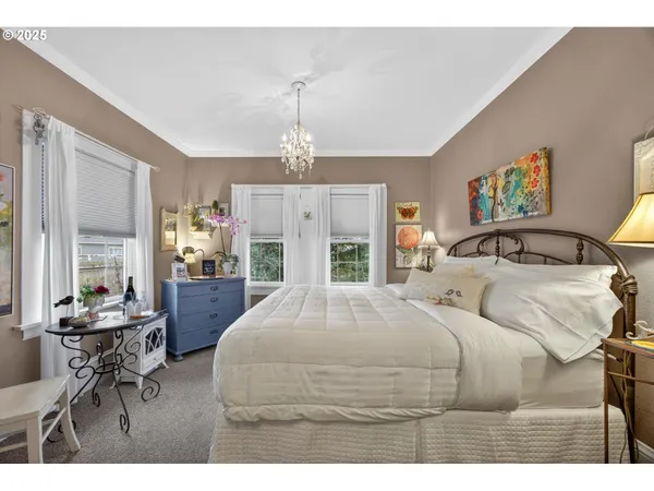 a bedroom with a bed and a chandelier