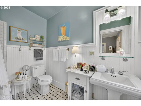 a bathroom with a sink toilet and a mirror