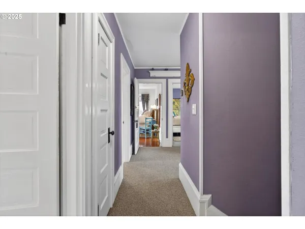 a view of a hallway with wooden shelves