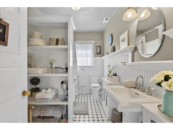 a bathroom with a sink mirror and vanity