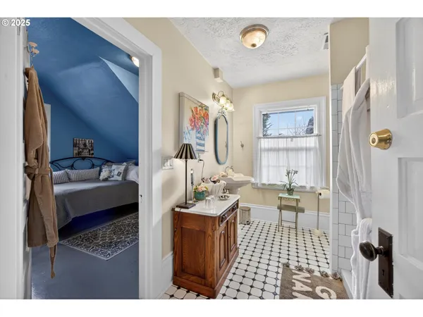 a bathroom with a sink a mirror and a shower