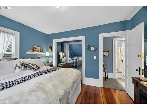 a bedroom with a large bed and a large mirror