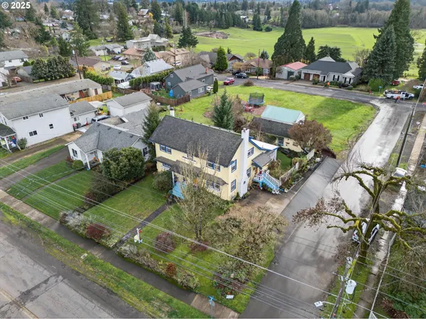 an aerial view of a house with a yard and a fountain