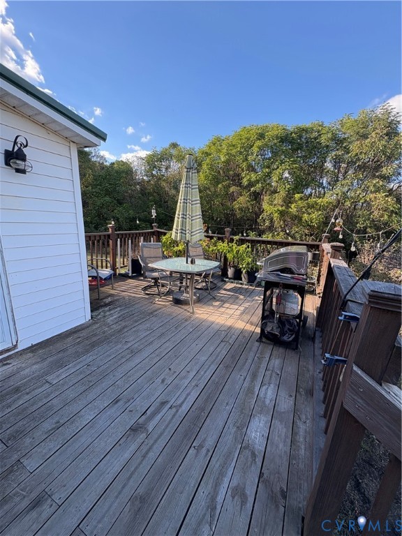 373 Chinquapin Road Prospect, VA 23960 - Photo 13 of 17 a view of roof deck with table and chairs a barbeque with wooden floor and fence