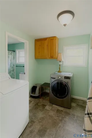 a utility room with sink dryer and washer
