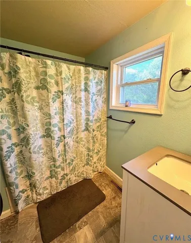 a bathroom with a bathtub and shower